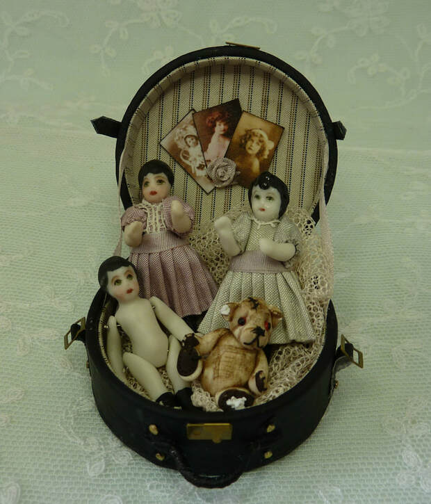 Dolls in a hat box